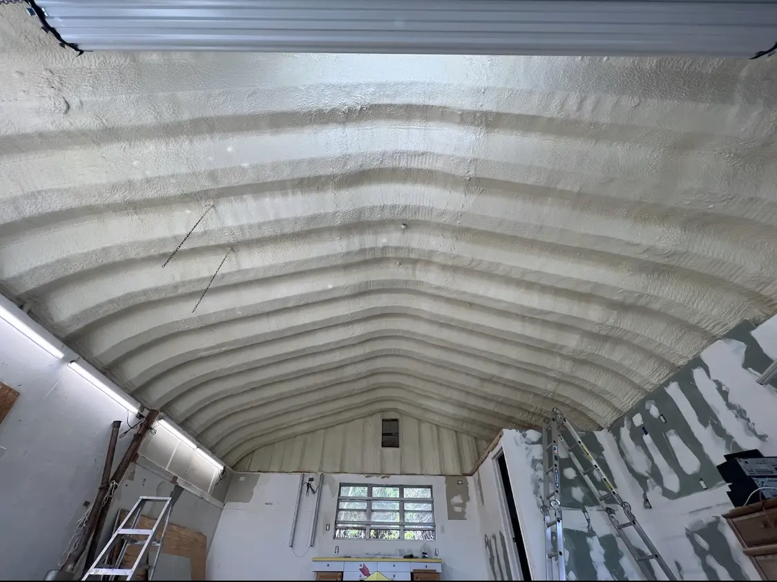 Spray polyurethane foam applied to the underside of a metal roof deck in St. Cloud